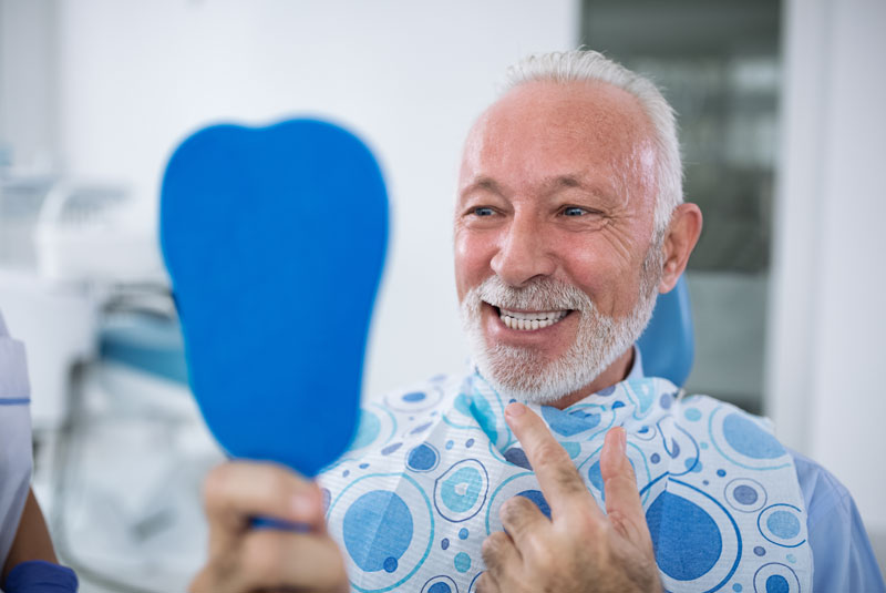 a dental patient smiling after successful dental implant surgery without anxiety